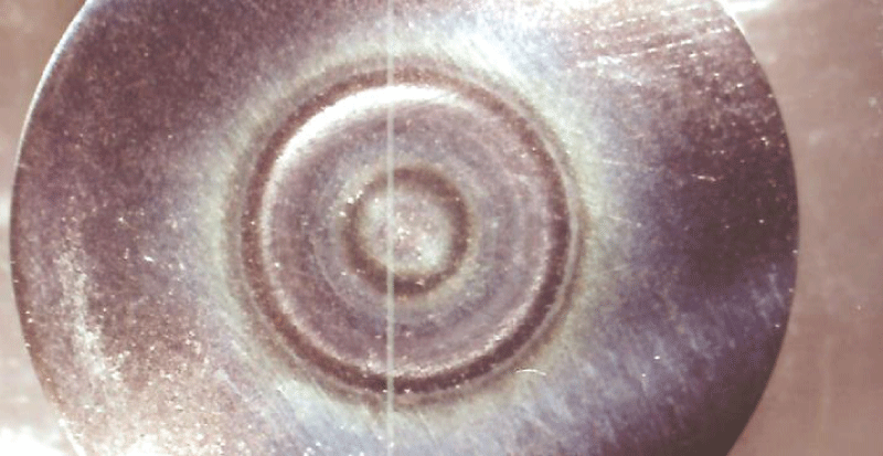 Ti/Al/V alloy after 12 hours of liquid impingement at 50 °C and 71 m/s without electrochemical intervention. (diameter of specimen = 26 mm).